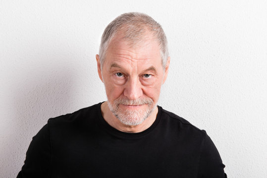 Senior Man In Black T-shirt, Looking Serious, Studio Shot.