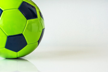 Closeup of green soccer ball on a white background. Hobby concept.