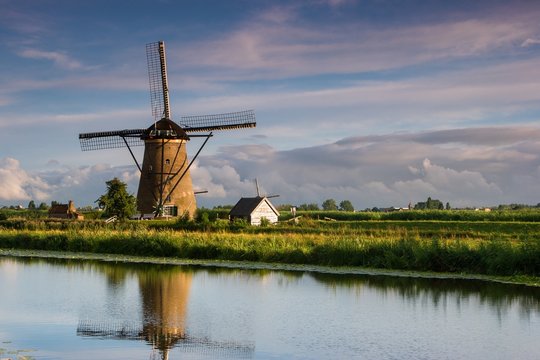 Scenic view of windmill against cloudy sky