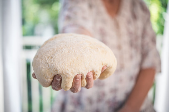 Bread dough hold by hand