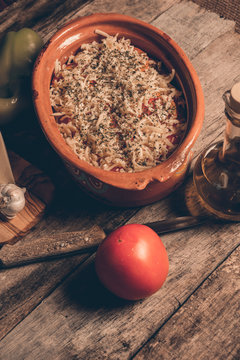 Uncooked Greek speciality Bujurdi in clay pot on rustic table