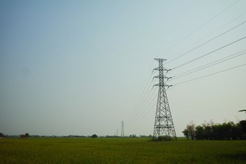  high voltage pole on field. countryside high voltage pole.