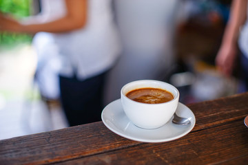 americano coffee in white cup on wood table.