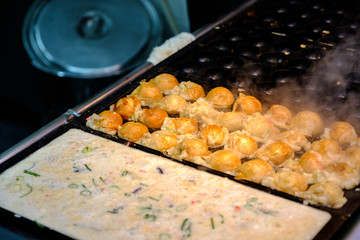 Takoyaki is a ball-shaped Japanese snack made of a wheat flour-based batter and cooked in a special moulded pan. It is typically filled with minced or diced octopus, tempura scraps, pickled ginger