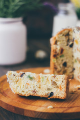 Easter cake divided on pieces over wooden board.