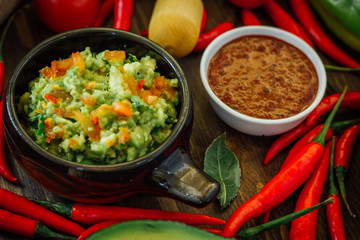 Guacamole and salsa - two hot mexican vegetarian dips.
