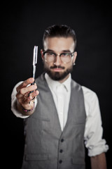 stylish hairdressers in the studio with blade for razor