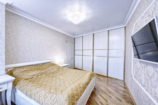 Russia, Moscow - modern designer renovation in a luxury building. Stylish bedroom interior with double bed.