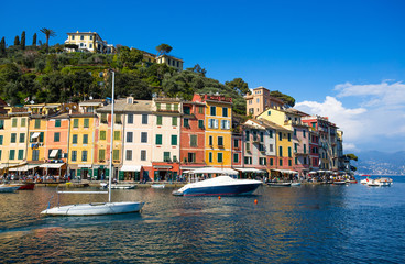 Fototapeta na wymiar PORTOFINO, ITALY, APRIL 8, 2017 - Panoramic view of Portofino, an Italian fishing village, Genoa province, Italy. A tourist place with a picturesque harbour and colorful houses