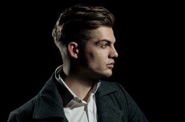 Handsome man with stylish blond hair posing with serious face