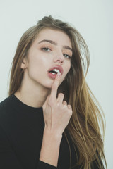 Pretty girl with hand on sexy lips