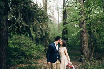 Wedding couple are walking in the forest