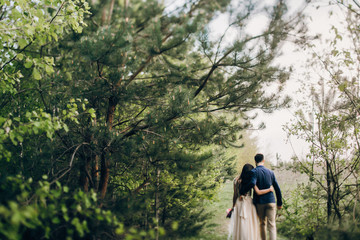 Walking wedding couple in the forest