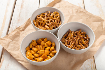 Pretzels in bowls on wooden table from above