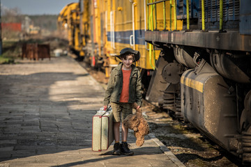 boy waiting at the railway station, Vacation trip by train 

