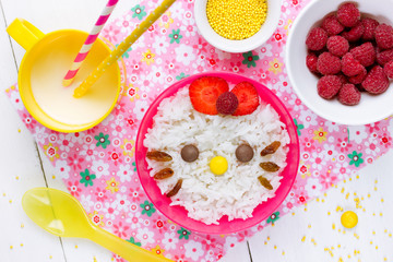 Milk rice porridge for kids healthy breakfast shaped cute kitty girl, creative idea for baby meal