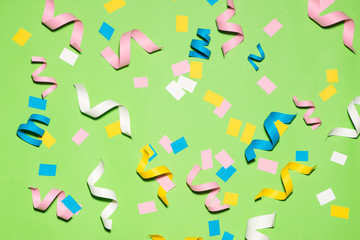 Celebration Flat lay with colorful party items on green background.