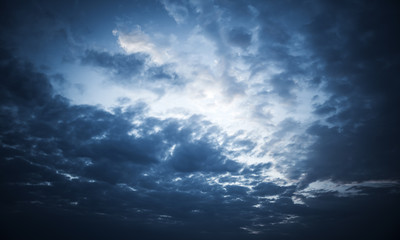 Naklejka na ściany i meble Dark blue night dramatic sky with stormy clouds