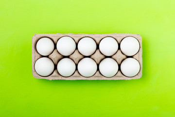 Colored easter eggs and willow on a yellow background