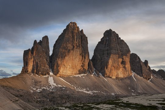 Scenic view of Tre Cime di Lavaredo against cloudy sky during sunset