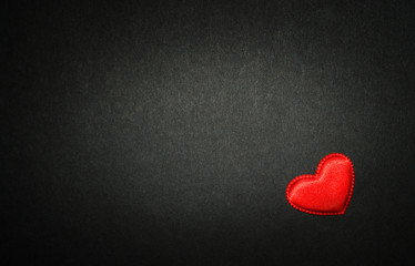 Obraz premium Red heart isolated on black paper. Love concept. Top view.