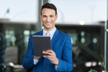 Portrait of a businessman using his tablet computer