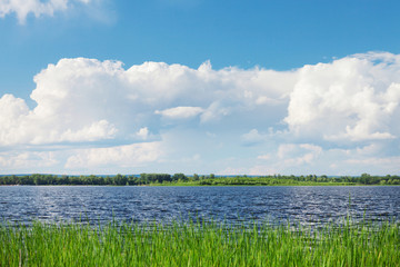 Landscape with river and cloudy sky
