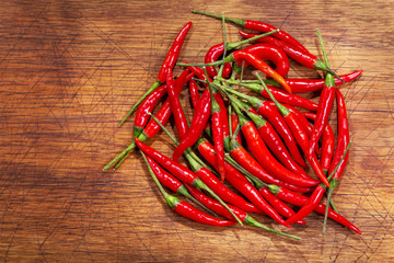 red chili peppers on old wooden board