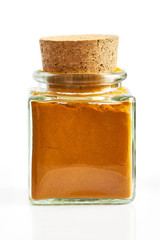Turmeric powder in glass spice jar