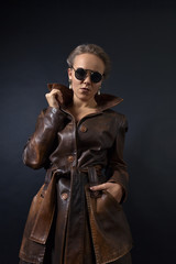 Portrait of young beautiful woman in brown leather coat