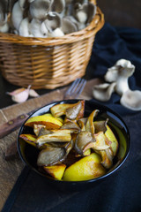 Homemade rustic food: potatoes with mushrooms closeup. vertical top view