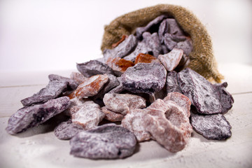 Died candied fruits and vegetables in the sack on white wooden surface closeup