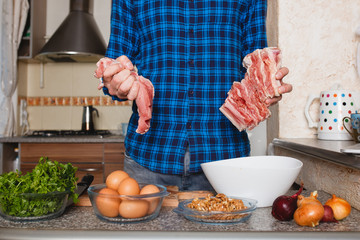 food and home concept - close up of male hand cutting