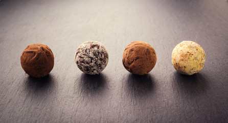 Chocolate truffle,Truffle chocolate candies with cocoa powder.Chocolate candies collection.Assorted chocolate truffles with cocoa powder, coconut and chopped hazelnuts on a dessert plate.