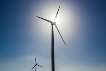 Wind turbines generating electricity with blue sky - energy conservation concept