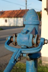 old blue public water pump