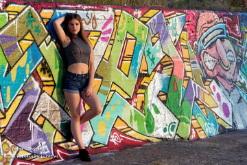 Young girl near graffiti wall