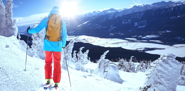 Composite image of skier with backpack on snowy field