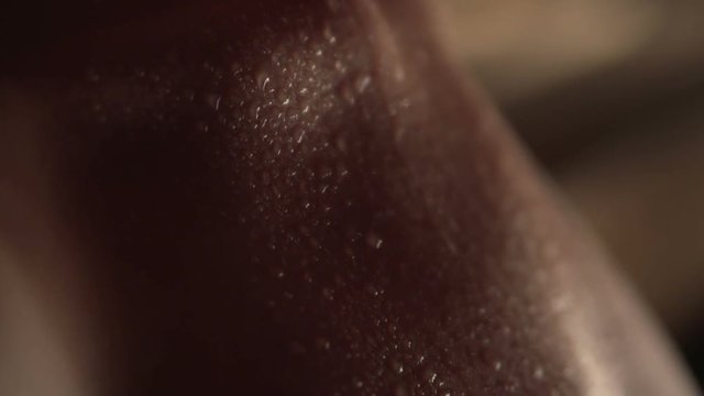 Sweaty woman in a nude relaxing in a wooden spa sauna. Beautiful young woman sitting in sauna and Sexually breathes. closeup Macro