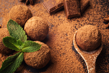 Chocolate truffle,Truffle chocolate candies with cocoa powder.Homemade fresh energy balls with chocolate.Gourmet assorted truffles made by chocolatier.Chunks of chocolate and coffee beans