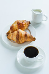 Breakfast. Coffee with milk and croissants. View from above.