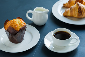 Breakfast. Coffee with milk muffin and croissants.