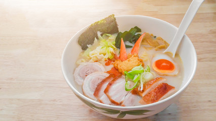 Asian food Japanese noodle tonkotsu ramen soup with pork , chicken , egg, chives , mushrooms and sprout on wooden background.