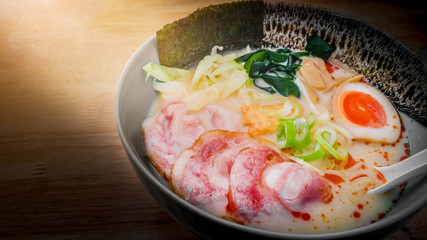 Asian food Japanese noodle tonkotsu ramen soup with pork , egg, chives , mushrooms and sprout on wooden background.