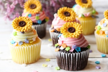 Spring Summer Cupcakes with edible sunflowers and buttercream frosting, selective focus