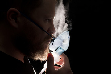 Man breathing through nebulizer mask