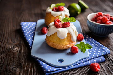 Mini lime bundt cakes with whipped cream and raspberries topping