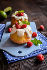 Mini lime bundt cakes with whipped cream and raspberries topping