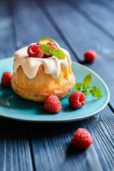 Mini lime bundt cakes with whipped cream and raspberries topping