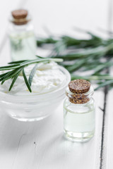 natural essential aroma oil with rosemary on wooden table background